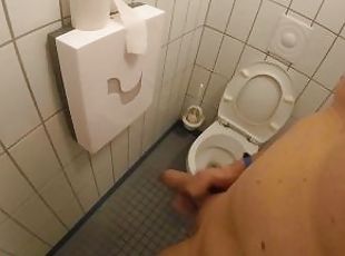 Naked jerking off and cum in the toilet next to a public shower room while people are pi and shower
