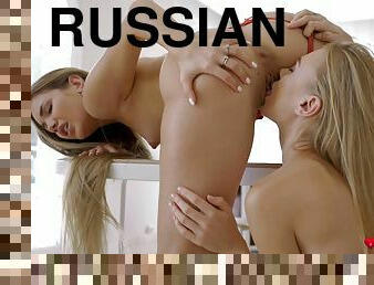 Two beautiful Russian girls licking on the table