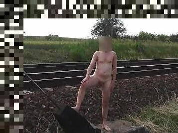 Naked man walks on railway tracks