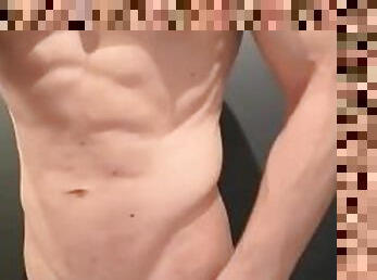 Strong boy undressing. Bodybuilder shows niked beautiful body