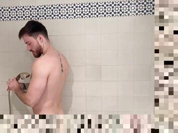 Muscular hairy hunk getting soapy in the shower