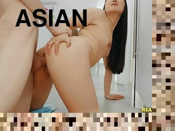 Asian brunette babe gets a doggy orgasm in the kitchen