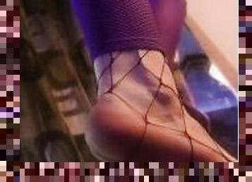 My workout leggings hide a lewd fishnet while I stretch my feet before yoga