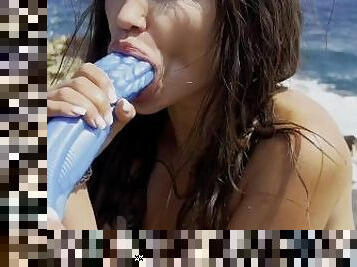 Hot pornstar Monika Foxxx masturbates and fucks herself with a big octopus dildo on a reef beach