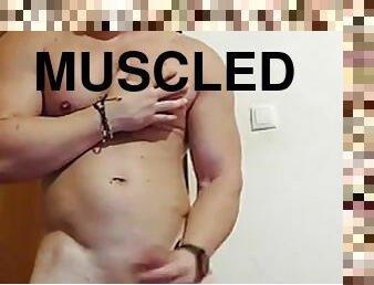 Muscle show and cumshot after tickling the head of the penis