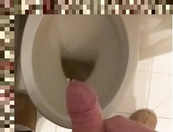 a guy pisses and then masturbates in the bathroom, cumming with his nice cock all over the place