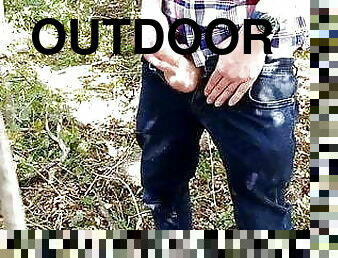 Jerking off outdoors in the corner of a field