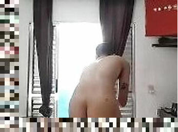 Caged nudist cleaning the room