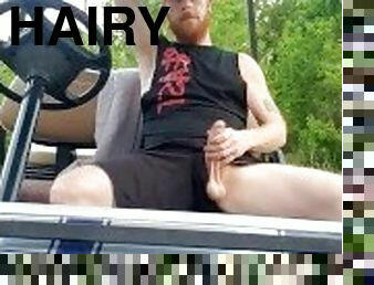 Hairy ginger showing off dick outdoors on golf cart