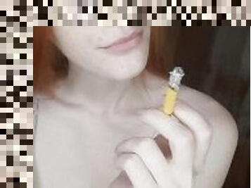 redhead girl smokes a cigarette