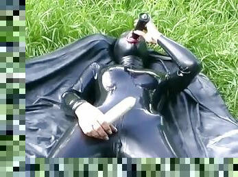 Rubber Girl Full in Black Latex Catsuit and Mask Plays with herself Outdoor in a Meadow - Part 4