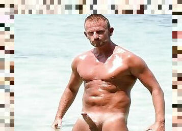 muscle hunk playing with his big dick on public beach