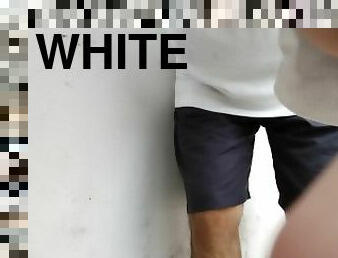 White boy pissing in a white wall