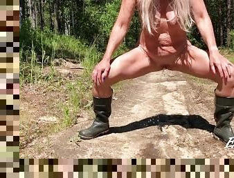 pissing in rubber boots and barefoot with legs wide apart