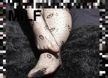 Close up of Wolf's cute feet in skull fishnets for your foot fetish pleasure