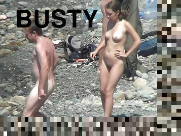 Sweet busty babes are getting naked on the beach