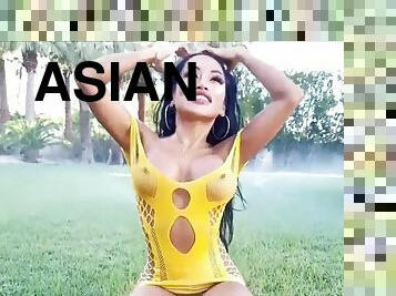 sexually attractive Asian with big boobs in skimpy yellow dress outdoors