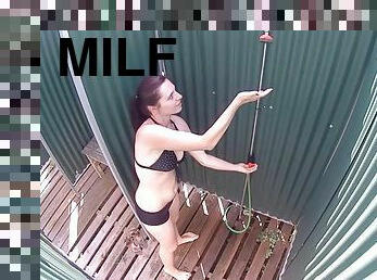 Brunette milf showering in the public pool