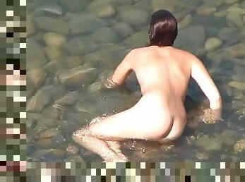 Long-haired nudist is swimming so sexy