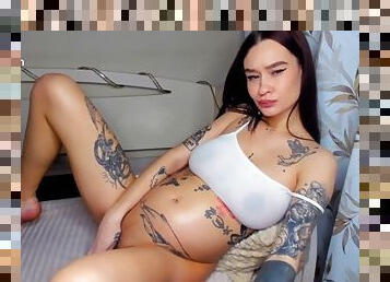 Tattooed girl fingers her pussy