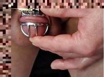 Oiled up putting on chastity cage