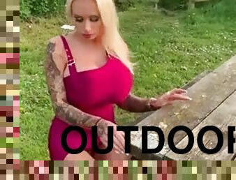 Fake titted bimbo plays with her pussy outdoors