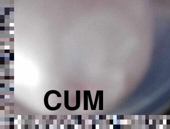 Jerking dick for cum in plastic cup.