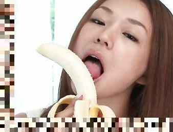 Beauty eats banana and sucks dildo lustily