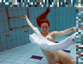 Redhead with big tits Lola underwater naked