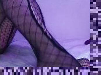 I crush a dildo with my feet in fishnet stockings