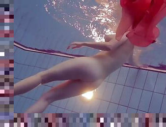Redhead girl privsem in red silk dress shows nude body underwater