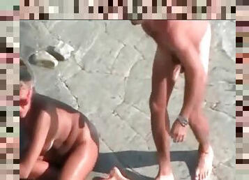 Naked blonde fucked doggystyle on the beach