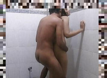Sexy cutie is standing and fucking in the shower