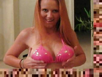 Cute redhead wearing a pink bikini shows her nice ass