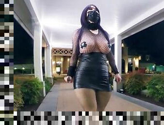 Crossdresser wearing PU leather and fishnets flashing outdoor