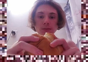 Naked chick eats burger while on the toilet
