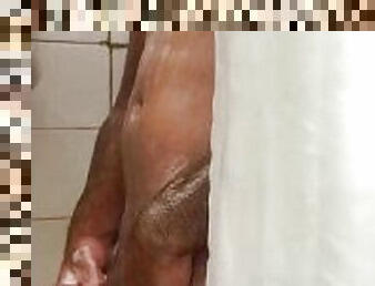 Boy masturbating his big uncut cock taking a shower